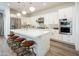 Spacious kitchen with a large quartz island, stainless steel appliances, and ample storage space in the white cabinetry at 2885 N 164Th Dr, Goodyear, AZ 85395