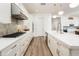 Gourmet kitchen with stainless steel appliances, white cabinets, a quartz countertop, and an expansive layout for cooking and entertaining at 2885 N 164Th Dr, Goodyear, AZ 85395