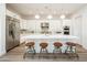 Modern kitchen featuring a large island with seating, stainless steel appliances, and sleek white cabinets for plenty of storage at 2885 N 164Th Dr, Goodyear, AZ 85395