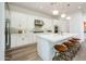 Well-lit kitchen with a quartz island, stainless steel appliances, and white cabinetry offering ample storage and counter space at 2885 N 164Th Dr, Goodyear, AZ 85395