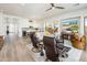 Open concept living room with light hardwood floors, modern furnishings, and a seamless flow to the kitchen and dining area at 2885 N 164Th Dr, Goodyear, AZ 85395