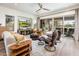 Inviting living room with wood floors, modern furniture, a ceiling fan, and a view of the outdoor patio at 2885 N 164Th Dr, Goodyear, AZ 85395