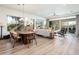 Open concept living space with wood floors, dining table, comfortable seating, and sliding glass doors to a patio at 2885 N 164Th Dr, Goodyear, AZ 85395