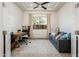 Well-lit home office offers a comfortable workspace and a relaxing seating area at 2885 N 164Th Dr, Goodyear, AZ 85395