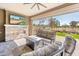 Covered patio boasts fireplace, TV, comfortable seating, and an outdoor view at 2885 N 164Th Dr, Goodyear, AZ 85395