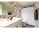 Bright bathroom with new vanity, wood framed mirror and tub shower at 3215 W Phelps Rd, Phoenix, AZ 85053