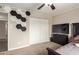 Bedroom with ceiling fan, TV, dresser and closet with sliding doors at 3215 W Phelps Rd, Phoenix, AZ 85053