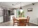 Cozy dining area with a round wooden table set and views to the landscaped yard at 3215 W Phelps Rd, Phoenix, AZ 85053