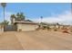 A long driveway leading to a two-car garage with a gate and desert landscaping at 3215 W Phelps Rd, Phoenix, AZ 85053