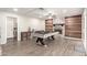 Entertainment area with a pool table, wood wall accent, and a stone fireplace at 3215 W Phelps Rd, Phoenix, AZ 85053