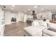 Open-concept living space showcasing a comfortable sectional sofa, adjacent workspace, and seamless access to the kitchen at 3215 W Phelps Rd, Phoenix, AZ 85053
