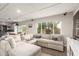 Spacious living area featuring a plush sectional sofa, entertainment center, and seamless transition to the kitchen at 3215 W Phelps Rd, Phoenix, AZ 85053