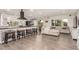 Bright, open-concept living area featuring a comfortable sectional sofa, modern appliances, and kitchen island seating at 3215 W Phelps Rd, Phoenix, AZ 85053