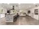 Expansive open-concept space featuring a large kitchen island, cozy living area, and modern design elements at 3215 W Phelps Rd, Phoenix, AZ 85053