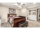 Main bedroom showcasing a sled bed, ceiling fan, ensuite bathroom, and carpet flooring at 3215 W Phelps Rd, Phoenix, AZ 85053