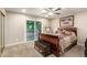 Comfortable main bedroom with a slider to back, a ceiling fan, and carpet flooring at 3215 W Phelps Rd, Phoenix, AZ 85053