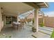 Outdoor living on large covered patio with pergola, lighting and manicured landscaping at 3215 W Phelps Rd, Phoenix, AZ 85053
