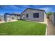 Lush backyard with a vibrant lawn, stylish pergola, and direct access to the covered patio area at 33974 N Beeblossom Trl, San Tan Valley, AZ 85144