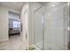 Modern bathroom with glass shower and tiled floors and view to the bedroom at 33974 N Beeblossom Trl, San Tan Valley, AZ 85144