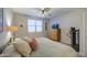 Bedroom with ample light, ceiling fan, dresser, and workout equipment at 33974 N Beeblossom Trl, San Tan Valley, AZ 85144
