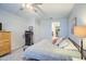 Bedroom featuring a ceiling fan, closet, dresser and workout equipment at 33974 N Beeblossom Trl, San Tan Valley, AZ 85144