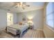 Well-lit bedroom featuring a ceiling fan and en-suite bathroom at 33974 N Beeblossom Trl, San Tan Valley, AZ 85144