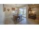 Cozy dining area with a wooden table, chairs, and natural light from sliding doors at 33974 N Beeblossom Trl, San Tan Valley, AZ 85144