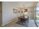 Bright dining area with a wooden table, chairs, and a view of the backyard through the sliding door at 33974 N Beeblossom Trl, San Tan Valley, AZ 85144