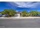 Street view featuring several single-story homes with desert landscaping, and attached two-car garages at 33974 N Beeblossom Trl, San Tan Valley, AZ 85144