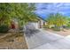 Well-maintained single-story home showcasing desert landscaping, a two-car garage, and an inviting entrance at 33974 N Beeblossom Trl, San Tan Valley, AZ 85144