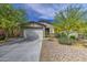 Charming single-story home featuring a two-car garage, desert landscaping, and a welcoming facade at 33974 N Beeblossom Trl, San Tan Valley, AZ 85144