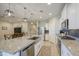 Open-concept kitchen with a large island, stainless steel appliances, and modern lighting at 33974 N Beeblossom Trl, San Tan Valley, AZ 85144