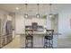 Spacious kitchen featuring a large island with seating, modern appliances, and stylish pendant lights at 33974 N Beeblossom Trl, San Tan Valley, AZ 85144