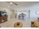 Spacious living area featuring tile flooring, a ceiling fan, and an open layout connecting to the kitchen at 33974 N Beeblossom Trl, San Tan Valley, AZ 85144