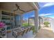 Charming covered patio features a cozy swing and a pergola overlooking the meticulously maintained lawn at 33974 N Beeblossom Trl, San Tan Valley, AZ 85144