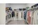 Spacious walk-in closet featuring built-in shelving and ample storage for clothes and personal items at 33974 N Beeblossom Trl, San Tan Valley, AZ 85144