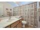 Cozy bathroom featuring a vanity with a sink, a large mirror, and a shower with a patterned curtain at 3973 N 160Th Ave, Goodyear, AZ 85395