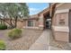 Charming home exterior with desert landscaping leading to a secure front entrance at 3973 N 160Th Ave, Goodyear, AZ 85395