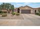 Single-story home with gravel yard, mature landscaping and a two-car garage at 3973 N 160Th Ave, Goodyear, AZ 85395