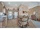 Spacious kitchen featuring a breakfast bar, tile floors, white appliances, and neutral decor at 3973 N 160Th Ave, Goodyear, AZ 85395