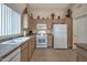 Eat-in kitchen with white appliances, tile flooring, and plenty of cabinet space at 3973 N 160Th Ave, Goodyear, AZ 85395