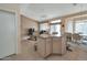 Open concept kitchen with a breakfast bar overlooking the living room and adjacent dining area at 3973 N 160Th Ave, Goodyear, AZ 85395
