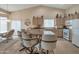Eat-in kitchen features a breakfast bar, tile floors, white appliances, and neutral decor at 3973 N 160Th Ave, Goodyear, AZ 85395