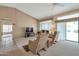 Comfortable living room with neutral walls, a ceiling fan, and a sliding door to the patio at 3973 N 160Th Ave, Goodyear, AZ 85395
