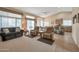 Bright living room with high ceilings, carpet floors, a ceiling fan, and access to the backyard at 3973 N 160Th Ave, Goodyear, AZ 85395