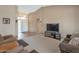 Inviting living room featuring neutral carpet, recessed lighting, and a large television at 3973 N 160Th Ave, Goodyear, AZ 85395