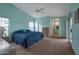 Spacious main bedroom with a blue bedspread, walk-in closet, en-suite bathroom, and ample natural light at 3973 N 160Th Ave, Goodyear, AZ 85395