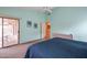 Bright main bedroom featuring a sliding glass door to the patio, a comfortable blue bed, and soft, light-filled space at 3973 N 160Th Ave, Goodyear, AZ 85395