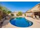 Beautiful backyard with a pool, lush landscaping, rock features, and outdoor seating at 462 S Marie Dr, Chandler, AZ 85225