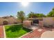 Well maintained backyard with green grass, a stone gas grill, and desert landscaping at 462 S Marie Dr, Chandler, AZ 85225